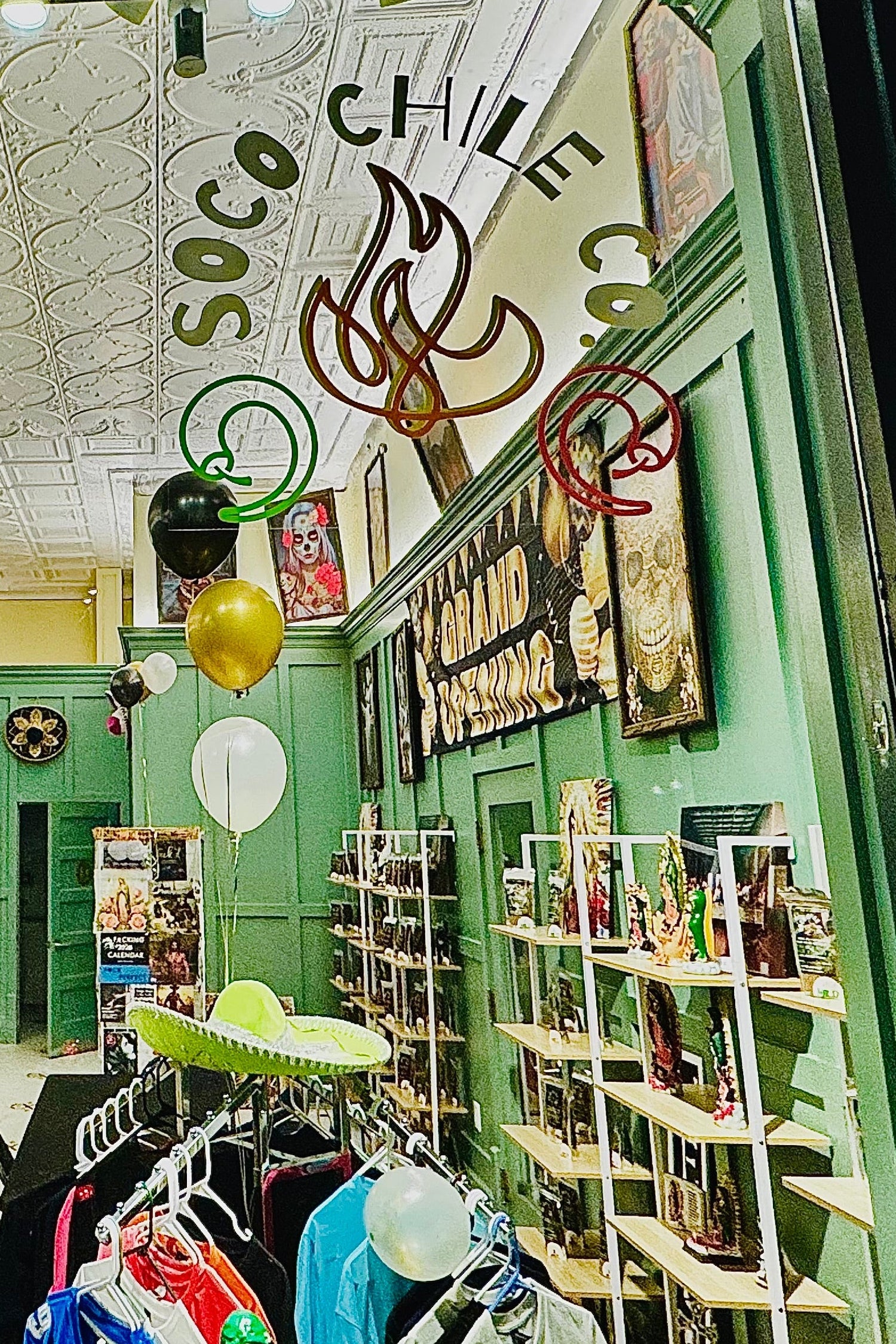 Interior of a store with green walls, shelves, and decorative elements.